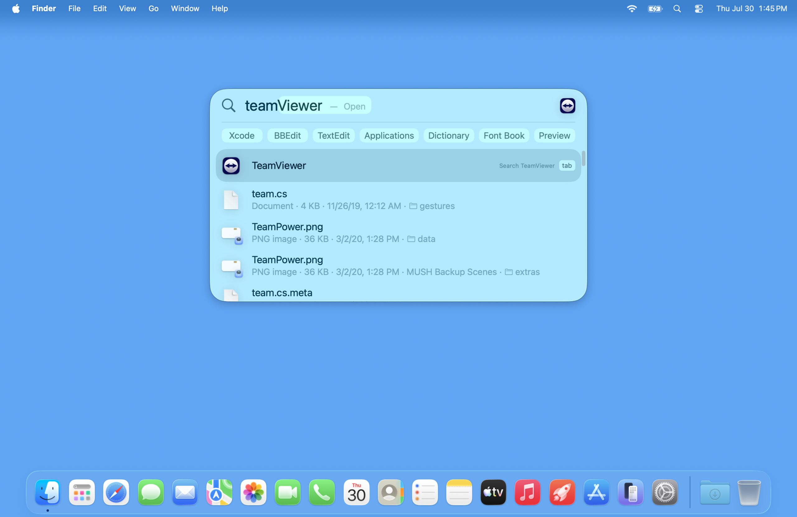 A screenshot of a Mac desktop with Spotlight search open, showing the results when typing in team. The rest of the word TeamViewer is Auto filled, and the TeamViewer application is highlighted in the first line of results. Other results include an image called team power and some text files with names like team.CS.